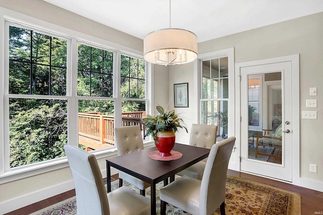 dining space with an inviting chandelier and dark hardwood / wood-style flooring