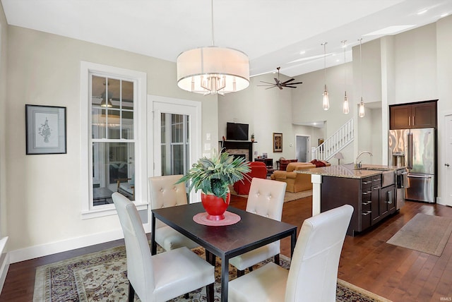 dining room with ceiling fan, dark hardwood / wood-style floors, and sink