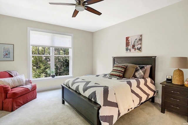 bedroom with ceiling fan and light carpet