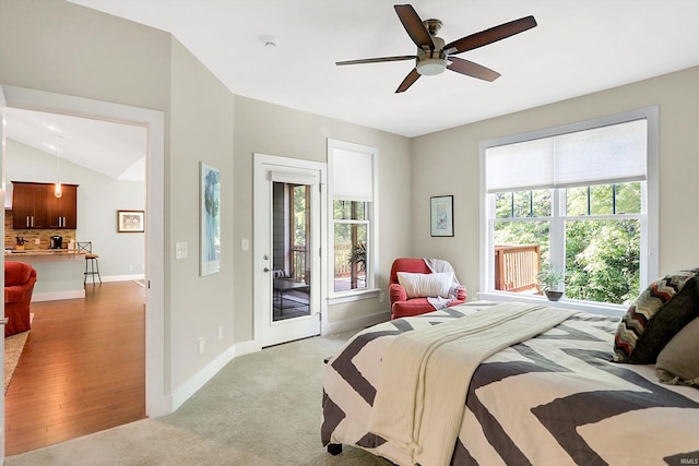 carpeted bedroom with vaulted ceiling, access to outside, and ceiling fan