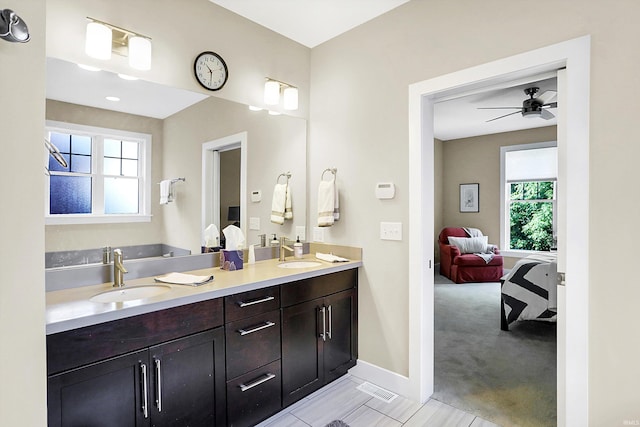 bathroom featuring tile patterned flooring, ceiling fan, and vanity