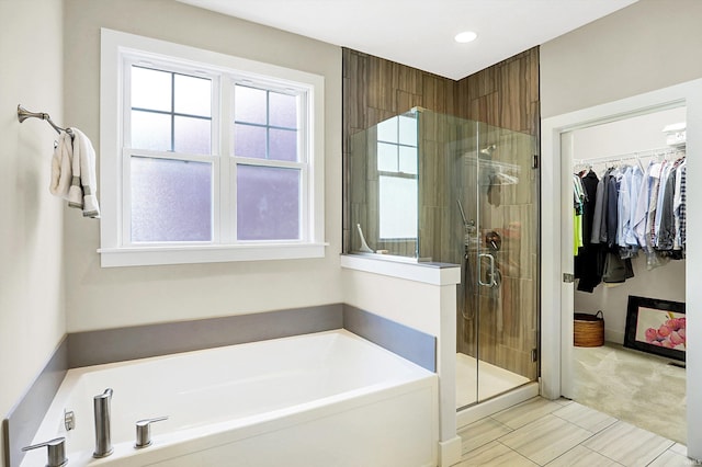 bathroom featuring shower with separate bathtub and tile patterned flooring