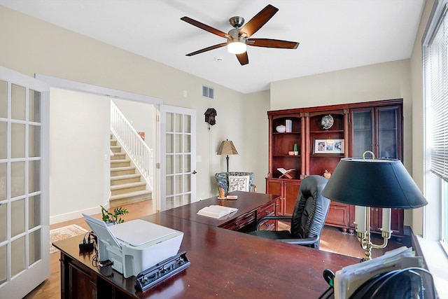 office area featuring light wood-type flooring, ceiling fan, and french doors