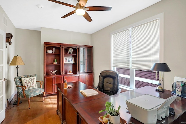 office space with light wood-type flooring and ceiling fan