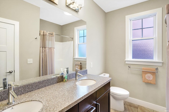 bathroom featuring vanity, toilet, curtained shower, and tile patterned floors