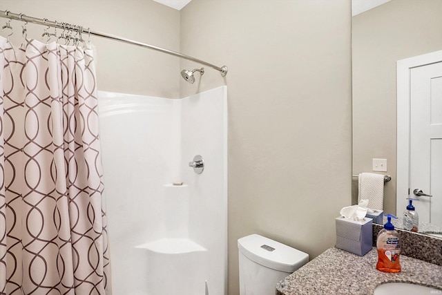 bathroom with a shower with shower curtain, toilet, and vanity