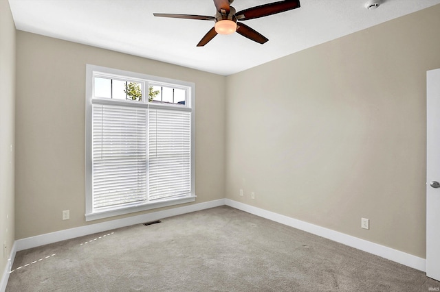 unfurnished room featuring ceiling fan and carpet floors