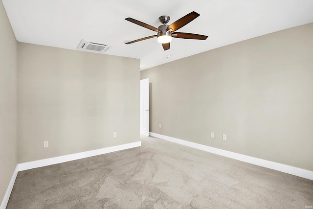 spare room with light colored carpet and ceiling fan