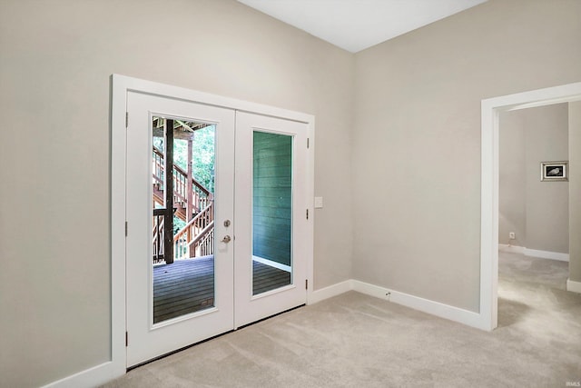 doorway to outside featuring light carpet and french doors