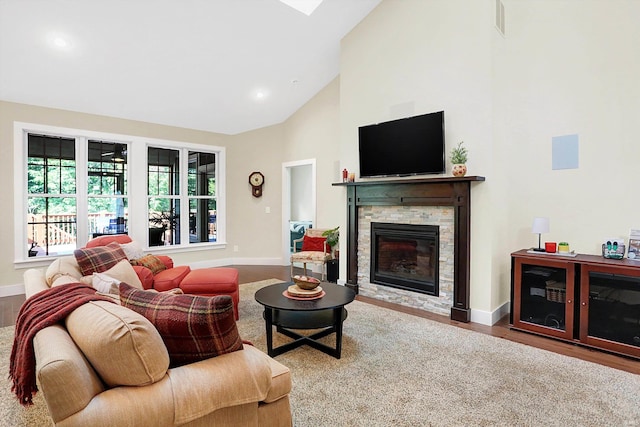 living room featuring a fireplace, high vaulted ceiling, and wood-type flooring