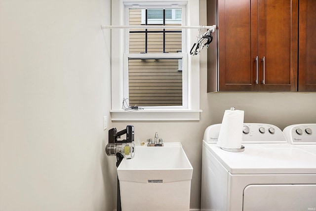 washroom featuring cabinets, washer and dryer, and sink