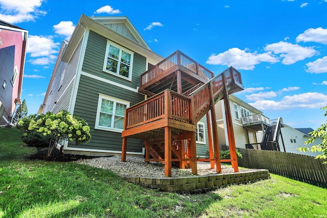 rear view of house with a lawn and a deck