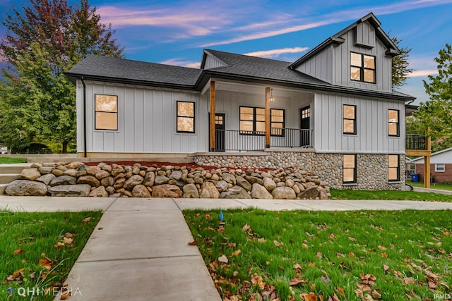 view of front of house with a lawn and covered porch