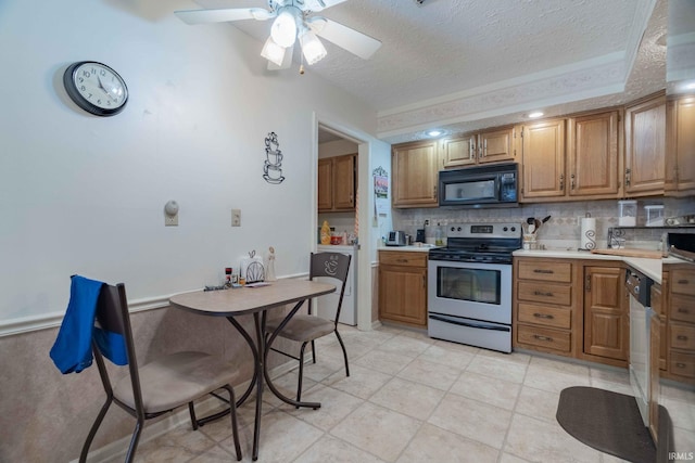 kitchen with ceiling fan, light tile patterned floors, stainless steel range with electric cooktop, and a textured ceiling