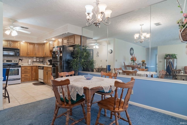 tiled dining space with ceiling fan with notable chandelier and a textured ceiling