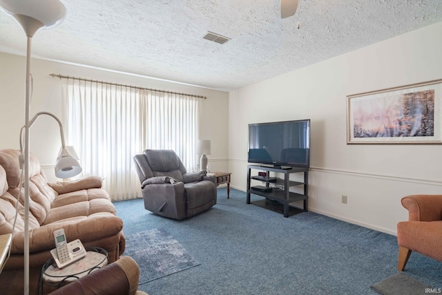 carpeted living room with a textured ceiling and ceiling fan