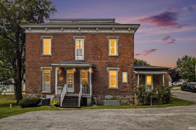 italianate home with cooling unit and covered porch