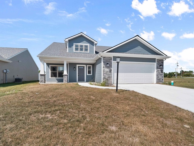 view of front of property featuring stone siding, central AC unit, and a front yard