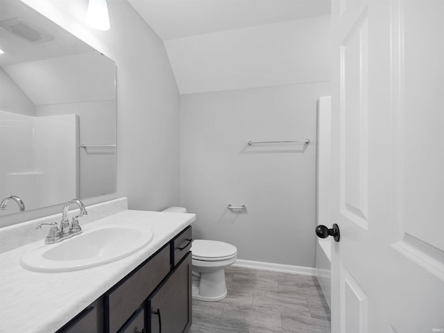 full bathroom with vaulted ceiling, toilet, vanity, and shower with separate bathtub