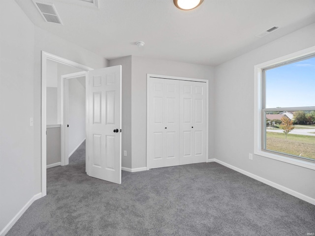 unfurnished bedroom featuring a closet and carpet floors