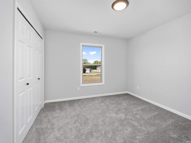 unfurnished bedroom with a closet and carpet floors