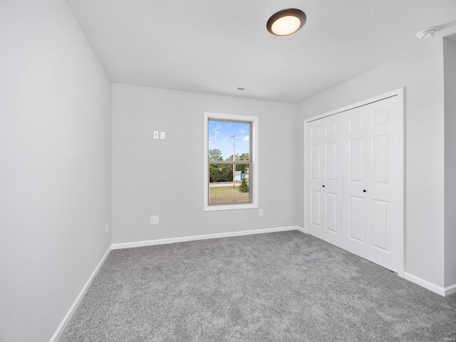 unfurnished bedroom with a closet and carpet floors