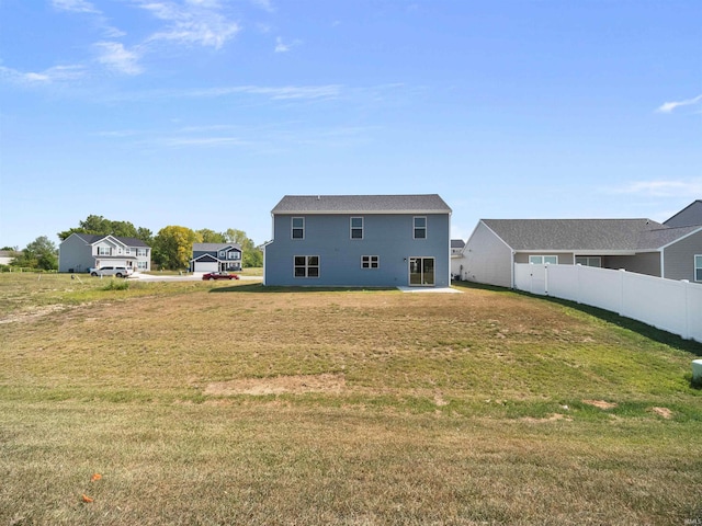 back of house featuring a yard