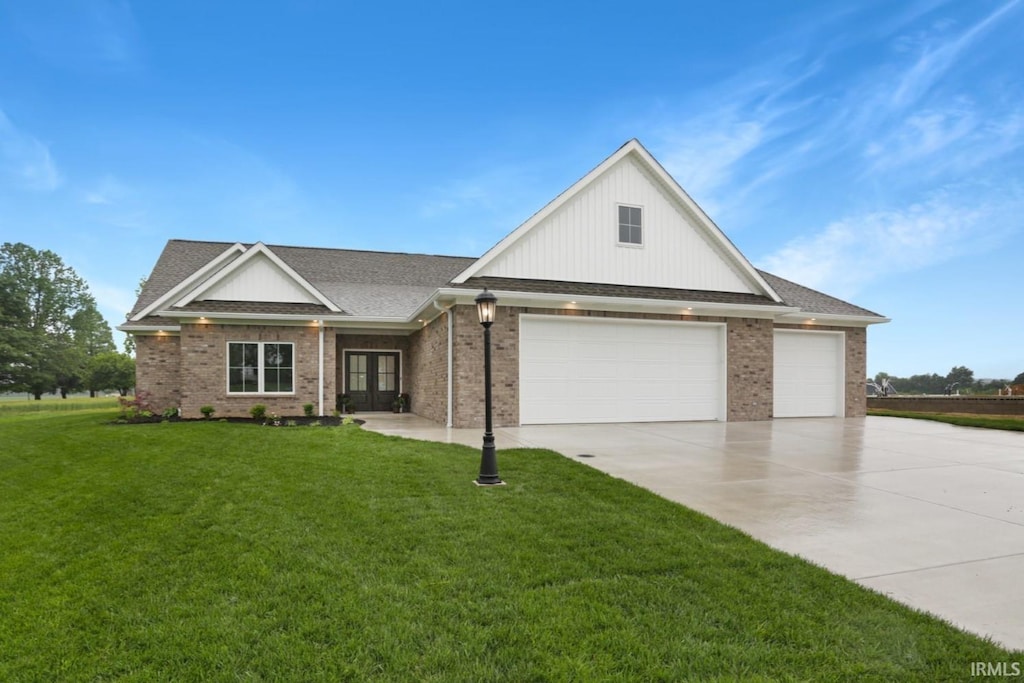 view of front of home with brick siding, an attached garage, concrete driveway, and a front yard