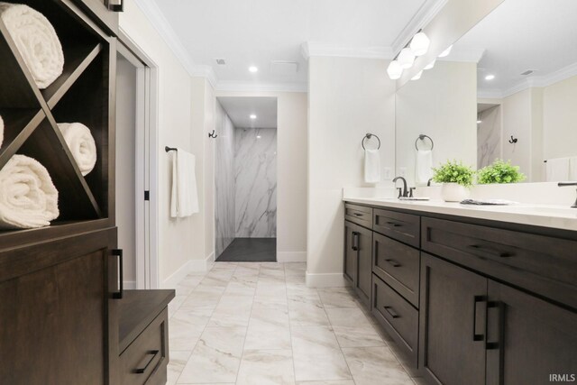 bathroom featuring tile patterned flooring, vanity, tiled shower, and crown molding