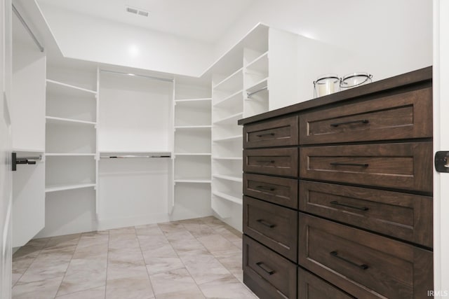 spacious closet with light tile patterned flooring