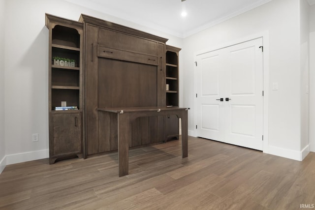 interior space with wood-type flooring and ornamental molding