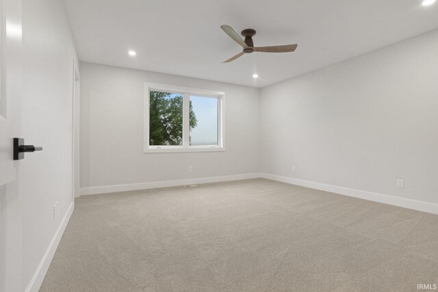 carpeted empty room with ceiling fan