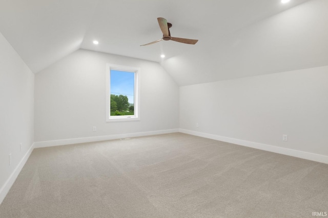 additional living space featuring lofted ceiling, light colored carpet, and ceiling fan