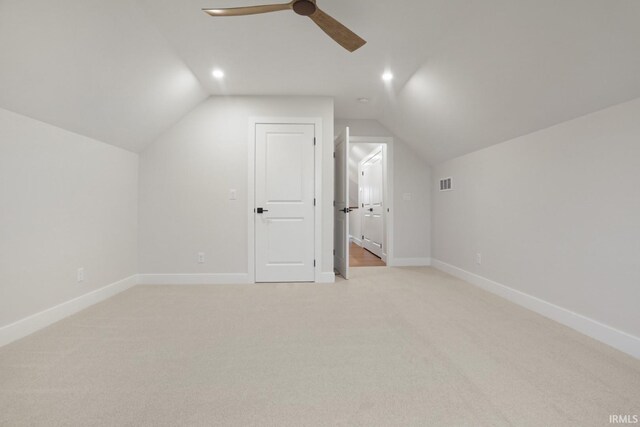 bonus room with lofted ceiling, ceiling fan, and light carpet