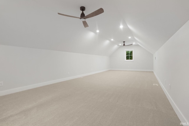 additional living space with lofted ceiling, ceiling fan, and light carpet