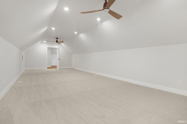 additional living space with lofted ceiling, ceiling fan, and light colored carpet