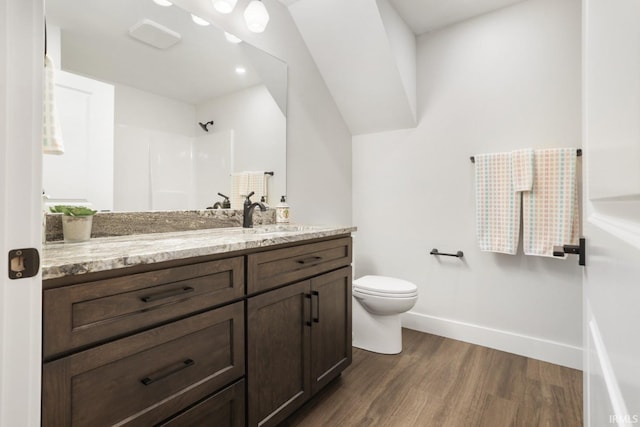 bathroom featuring vanity, toilet, hardwood / wood-style floors, and a shower