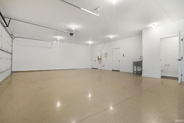 garage featuring sink and a garage door opener