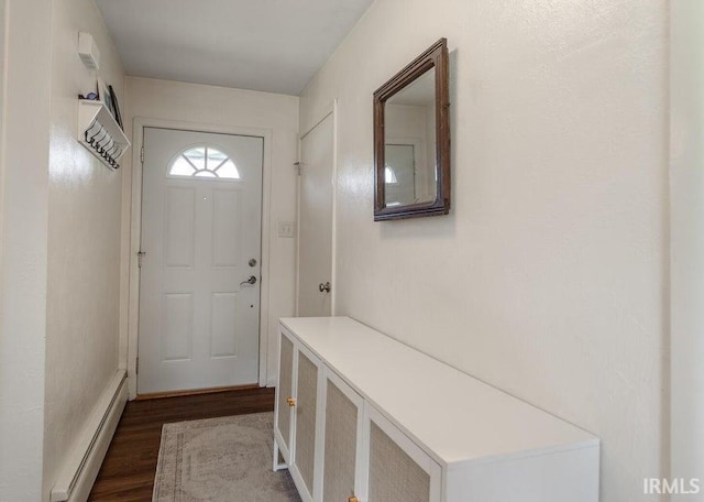 doorway with dark wood-style floors and baseboard heating