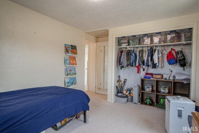 bedroom featuring a closet and carpet