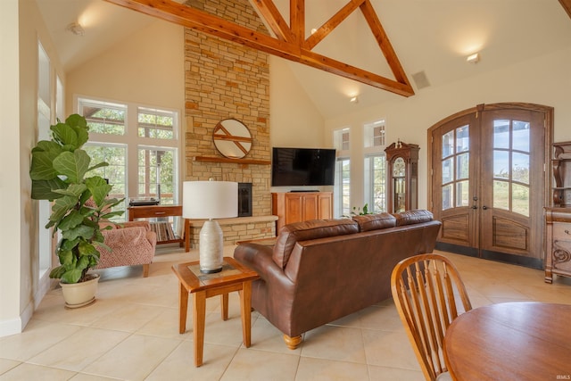 living area with beamed ceiling, high vaulted ceiling, french doors, and light tile patterned floors