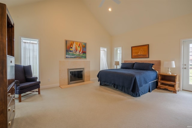 carpeted bedroom with baseboards, high vaulted ceiling, recessed lighting, and a premium fireplace
