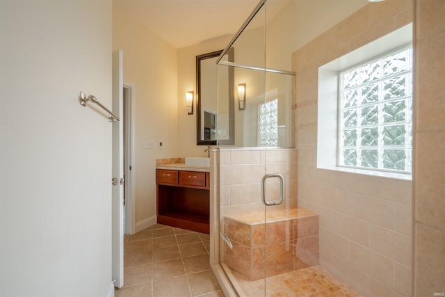 bathroom featuring tile patterned floors, vanity, and a stall shower