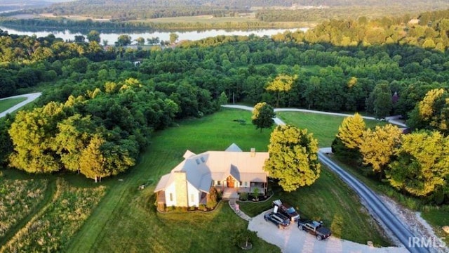 drone / aerial view featuring a water view and a view of trees