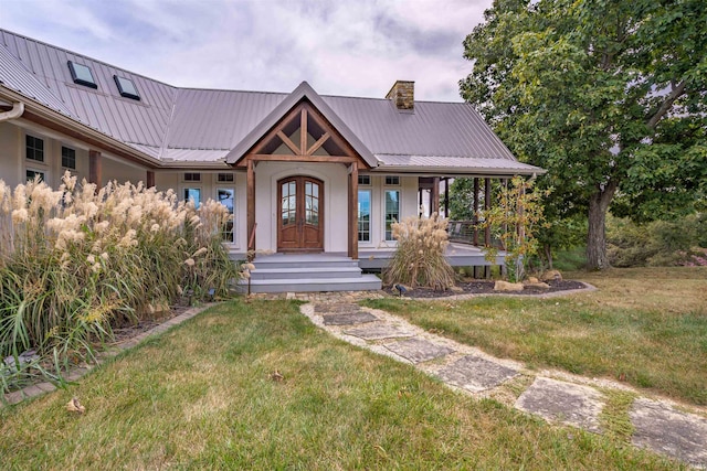14830 Vista Ridge Ln, Derby, IN 47525 - view of front facade with a chimney, french doors, covered porch, a front yard, and metal roof