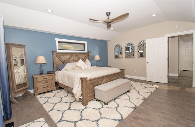 bedroom featuring baseboards, vaulted ceiling, wood finished floors, and recessed lighting