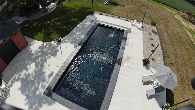 view of pool with a yard