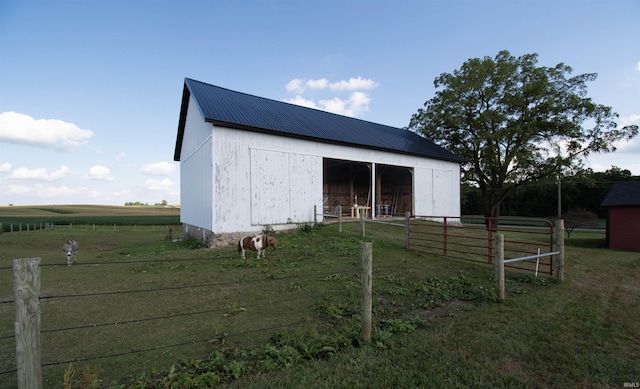 view of outdoor structure featuring a rural view and an outdoor structure