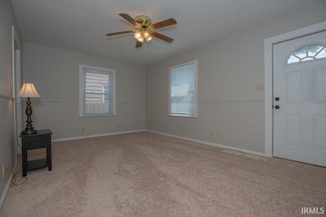 carpeted entrance foyer featuring ceiling fan