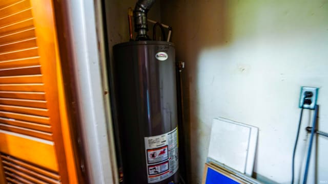 utility room with gas water heater